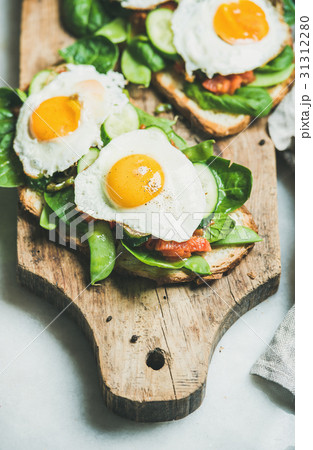 Healthy breakfast sandwiches on wooden board over 31312280