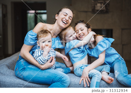 Mom, two daughters and a little son on the couch 31312934