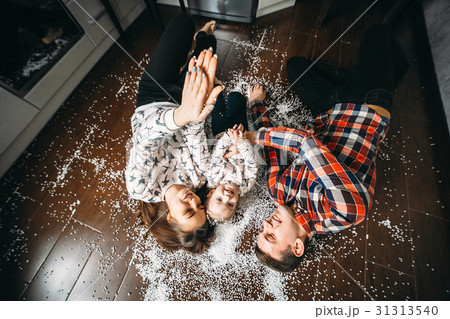 Happy family playing together on the floor Happy family playing together on the floor 31313540