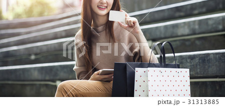 Beautiful asian woman with shopping bags and a card Beautiful asian woman with shopping bags and a card 31313885
