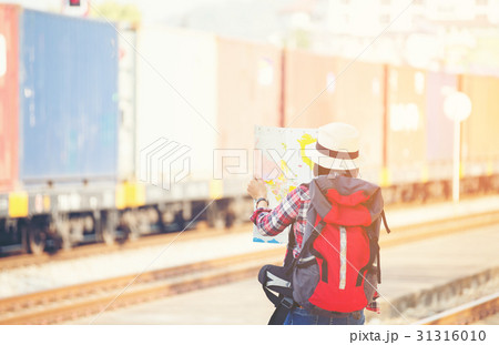 Traveler women wearing backpack holding map, waiti 31316010