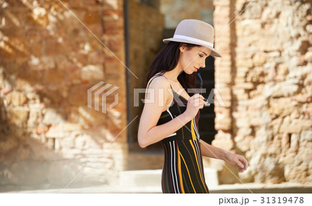 Fashionably dressed woman on the streets of a small Italian town 31319478