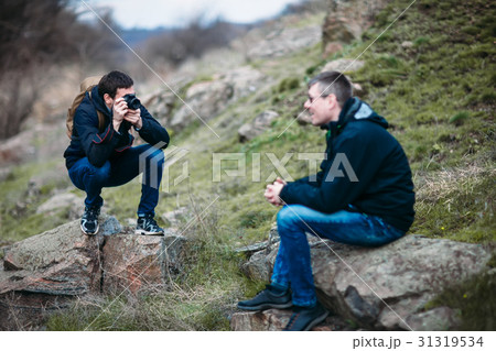 Photographer in action takes pictures of man 31319534