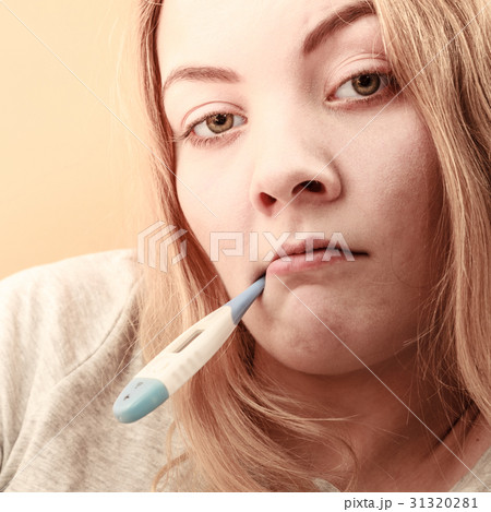 Sick ill woman with digital thermometer in mouth. Sick ill woman with digital thermometer in mouth. 31320281