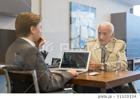Financial advisor consulting senior client with Financial advisor consulting senior client with 31320334