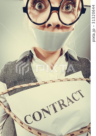 Businesswoman bound by contract with taped mouth. 31320644