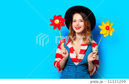 smiling woman with two pinwheels smiling woman with two pinwheels 31321209