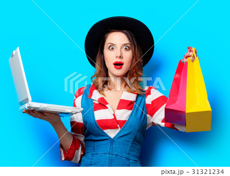 woman with laptop and shopping bags woman with laptop and shopping bags 31321234