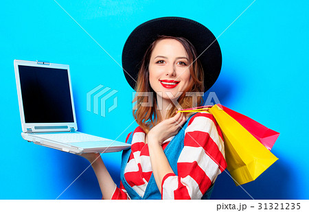 Woman with laptop and shopping bags Woman with laptop and shopping bags 31321235