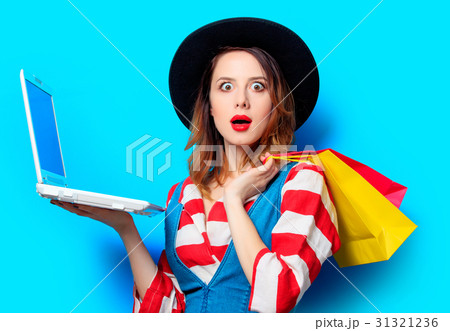 woman with laptop and shopping bags woman with laptop and shopping bags 31321236