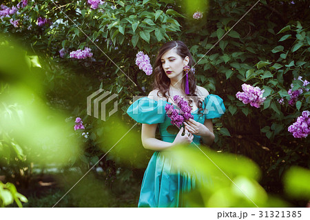 Sad woman with a branch of lilac. Sad woman with a branch of lilac. 31321385