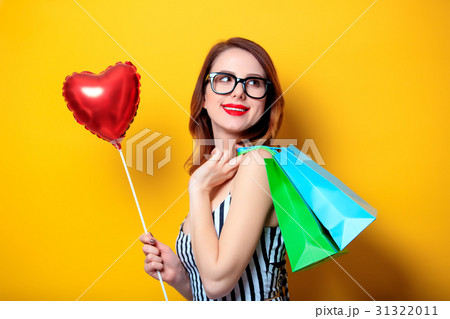 Woman with shopping bags and heart 31322011
