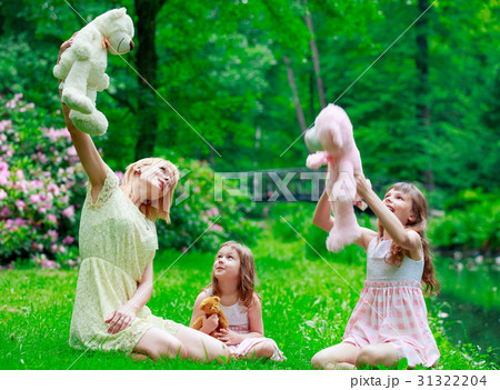Young mother and two sisters in park Young mother and two sisters in park 31322204