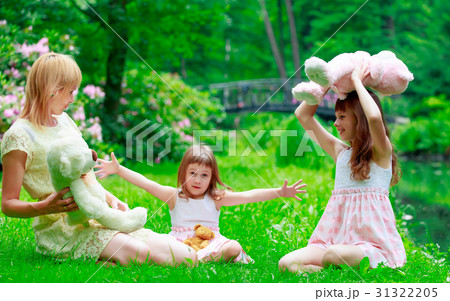 Young mother and two sisters in park Young mother and two sisters in park 31322205