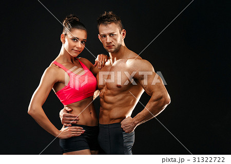 Two fit sportspeople posing together, close to 31322722