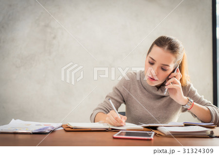 Young attractive girl talking on mobile phone Young attractive girl talking on mobile phone 31324309