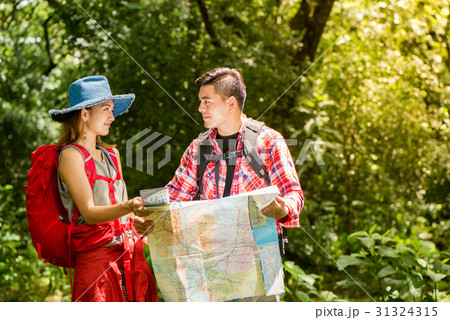 Hiking - hikers looking at map. Hiking - hikers looking at map. 31324315