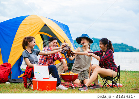 Group of man and woman enjoy camping picnic Group of man and woman enjoy camping picnic 31324317