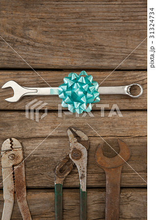 Wrench with ribbon by hand tools on table Wrench with ribbon by hand tools on table 31324734