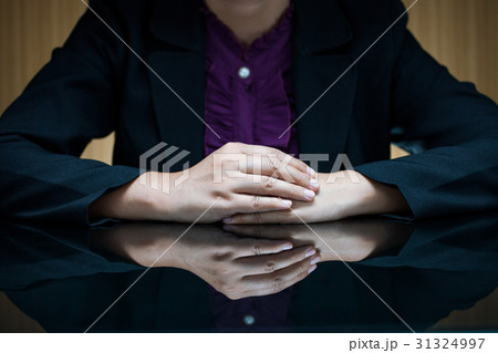 Businesswoman sitting at a desk and clasp her hand 31324997