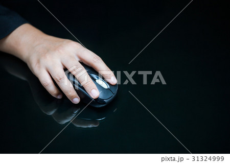Close-up of businesswoman's hand on computer mouse 31324999