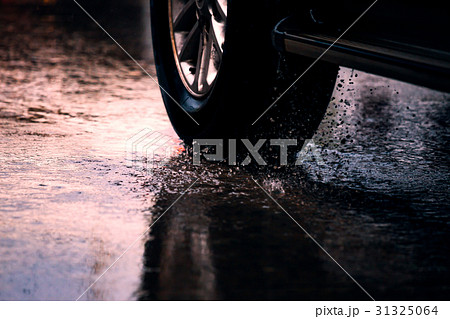 Motion car in rain big puddle with water splashing 31325064