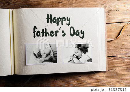 Photo album with pictures of father and baby son 31327315