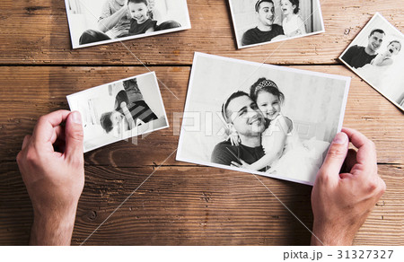 Pictures of father and daughter, wooden background 31327327