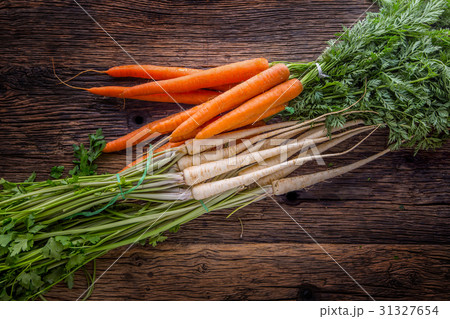 Celery carrot and parsnip on rustic oak table. Celery carrot and parsnip on rustic oak table. 31327654