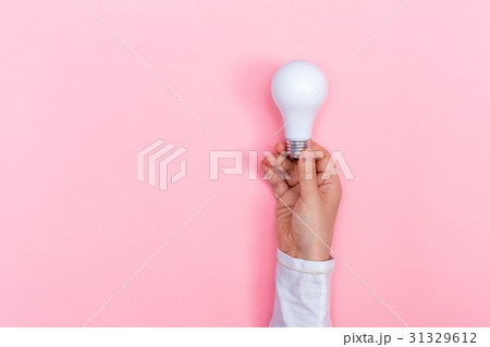 Colored light bulb being held up Colored light bulb being held up 31329612