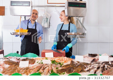 Ordinary fish and seafood store with two sellers indoors 31332707