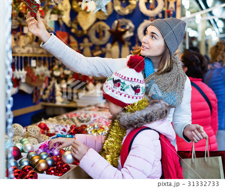 Female customers staring at counter of Christmas market Female customers staring at counter of Christmas market 31332733