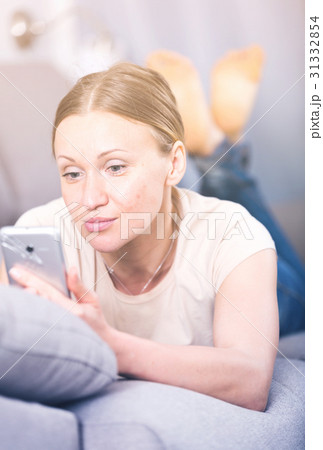 Upset woman with phone Upset woman with phone 31332854