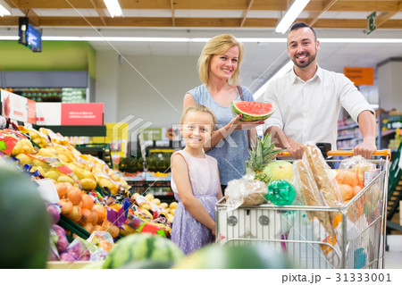 Happy man and woman with girl picking fruits Happy man and woman with girl picking fruits 31333001