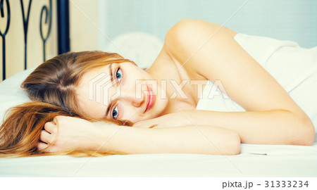Portrait of pretty girl awake in bed. 31333234