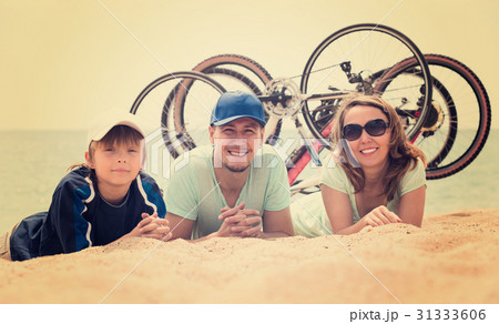 Family with bicycles on beach Family with bicycles on beach 31333606