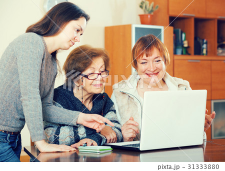 pensioners and relative working on laptop pensioners and relative working on laptop 31333880