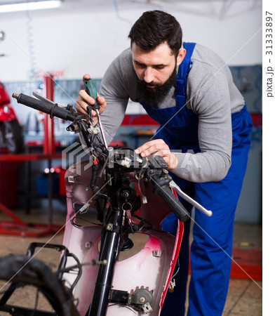 Worker repairing motorbike 31333897
