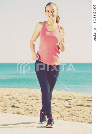 female jogging at sea beach 31333934