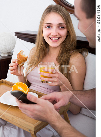 Couple with breakfast in bed 31334166