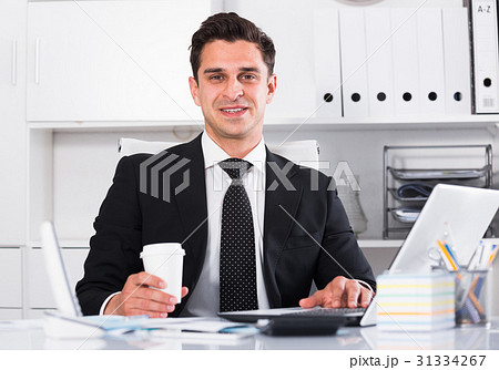 Smiling manager working on laptop 31334267