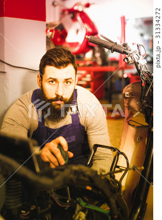 Worker repairing motorbike 31334272