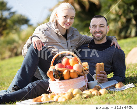 Couple lounging at picnic outdoors 31334406