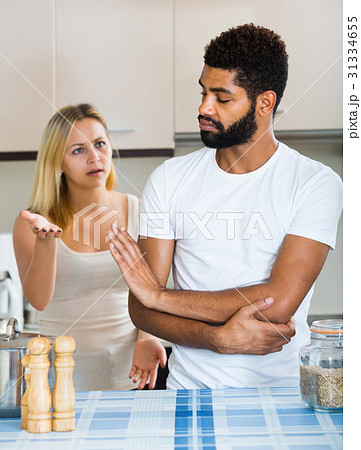 interracial family couple with serious faces quarrelling in kitchen interracial family couple with serious faces quarrelling in kitchen 31334655