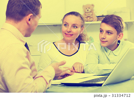 Mother and son signing documents 31334712
