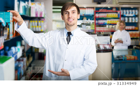 Pharmacist and pharmacy technician posing in drugstore 31334949