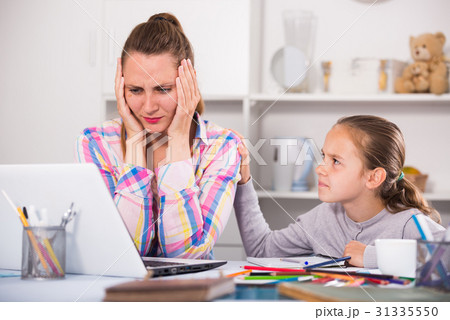Portrait of sad female with little schoolgirl 31335550