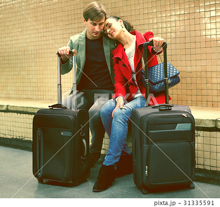 Young passengers with luggage waiting for train at subway station 31335591