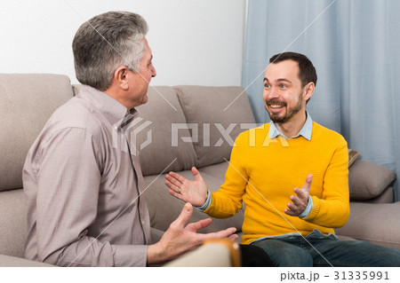 Adult father and son friendly conversation Adult father and son friendly conversation 31335991