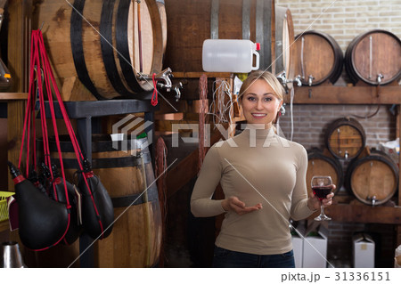 Woman selecting wine in wine house. Woman selecting wine in wine house. 31336151